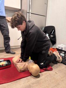 Scout performing CPR on a manakin.